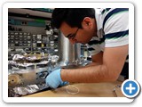Grad student Behshad Roshanzadeh adjusts a Spectrophotometer, which measures light absorption of various materials at 3 degrees Kelvin (Boyd)