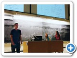 Undergraduate Montie Avery explains his research as Alex Doerfler and Associate Professor Mousumi Roy look on