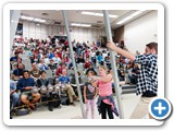 Audience members participate in a demonstration of the conservation of momentum and energy