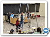 Demonstrating the Giant Newton's Cradle with an enthusiastic young audience member