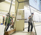 Students roll out a Giant Newton's Cradle at the Demo show